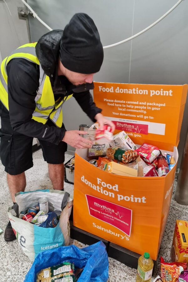 Volunteer getting food from Sainsbury's food collection baskets