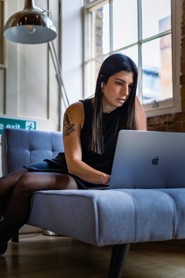Woman on her MacBook Pro doing admin work