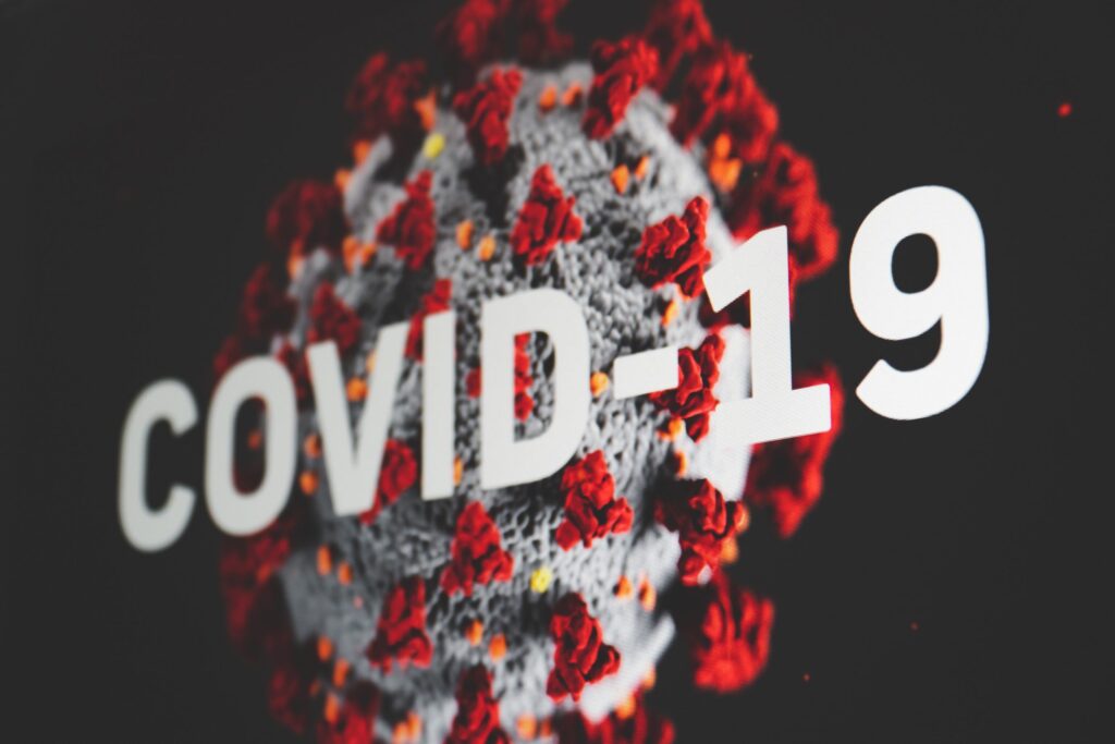 "Covid-19" in bold white text over an image of a round molecule representing Covid