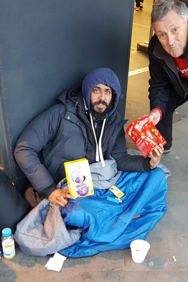 A happy homeless man receiving gifts from ROL